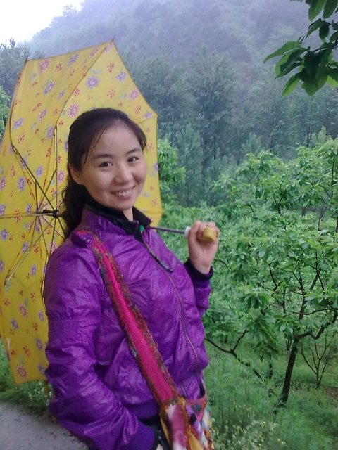 Yuxiang standing in front of a chestnut orchard